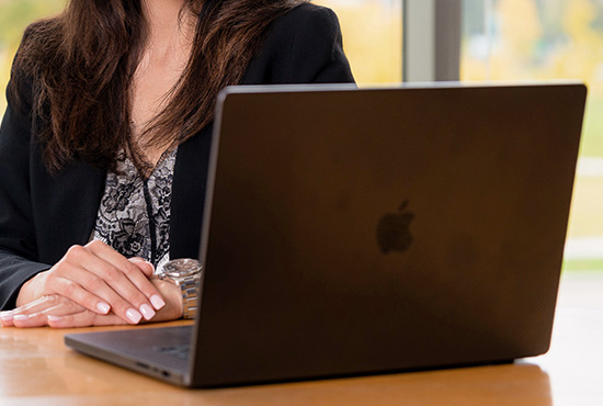 Woman working on laptop.